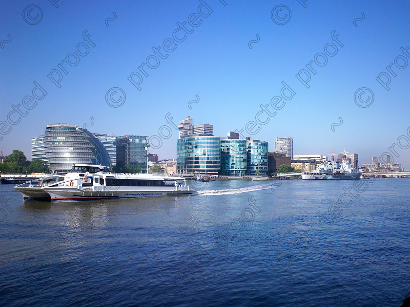 Thames- 001 
 View of City Hall, modern office buildings & water taxi. 
 Keywords: London, Thames, water taxi, boat, HMS Belfast, City Hall, river, water